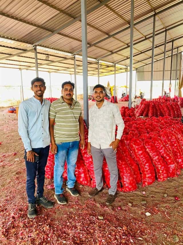 The P.S AgriExports team at the facility with export-ready red onions in mesh bags
